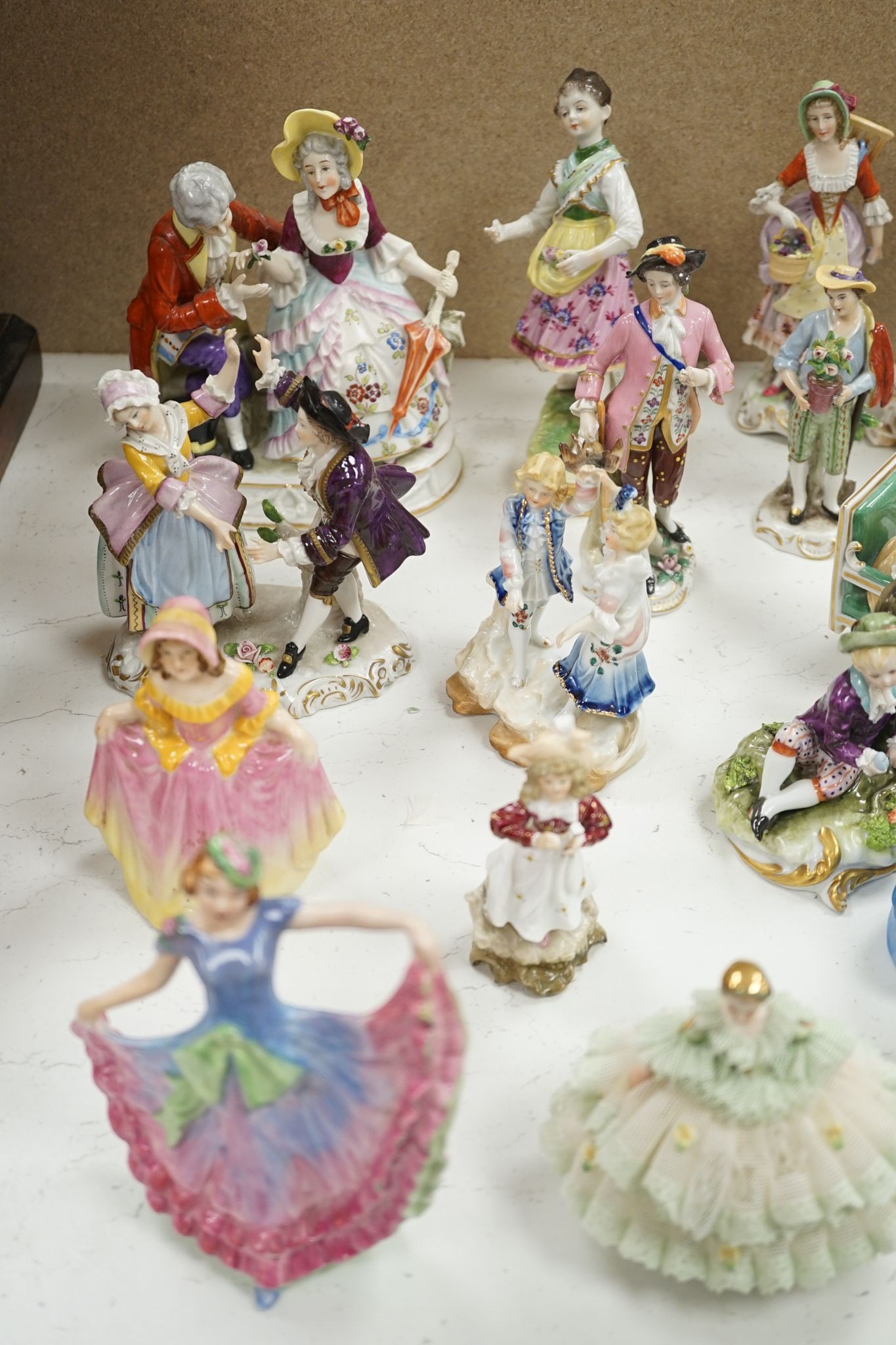A large collection of small to medium German, French and English porcelain figurines and groups, tallest 18cm